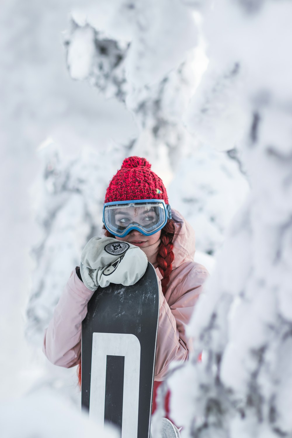 woman in red jacket wearing black goggles