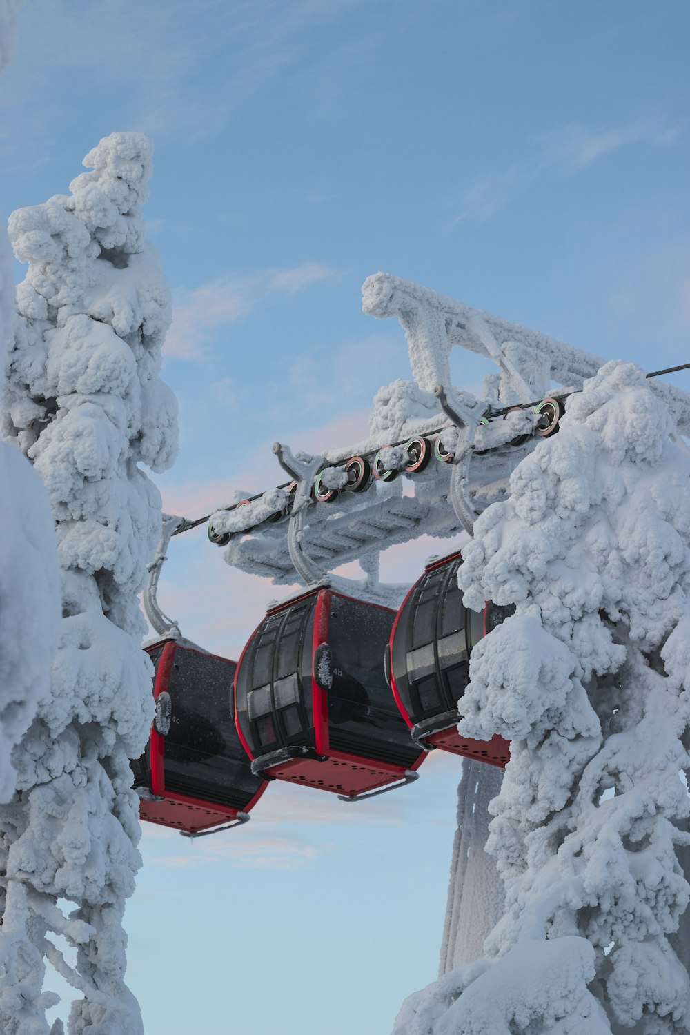 red and black cable car under white clouds and blue sky during daytime