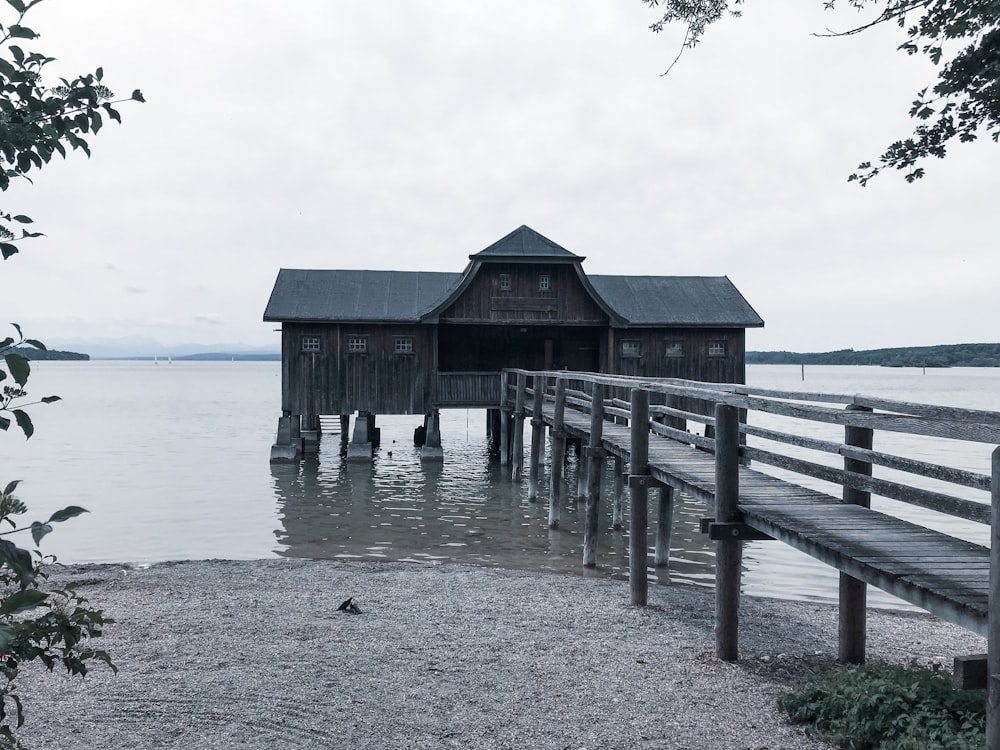 brown wooden house on sea dock during daytime