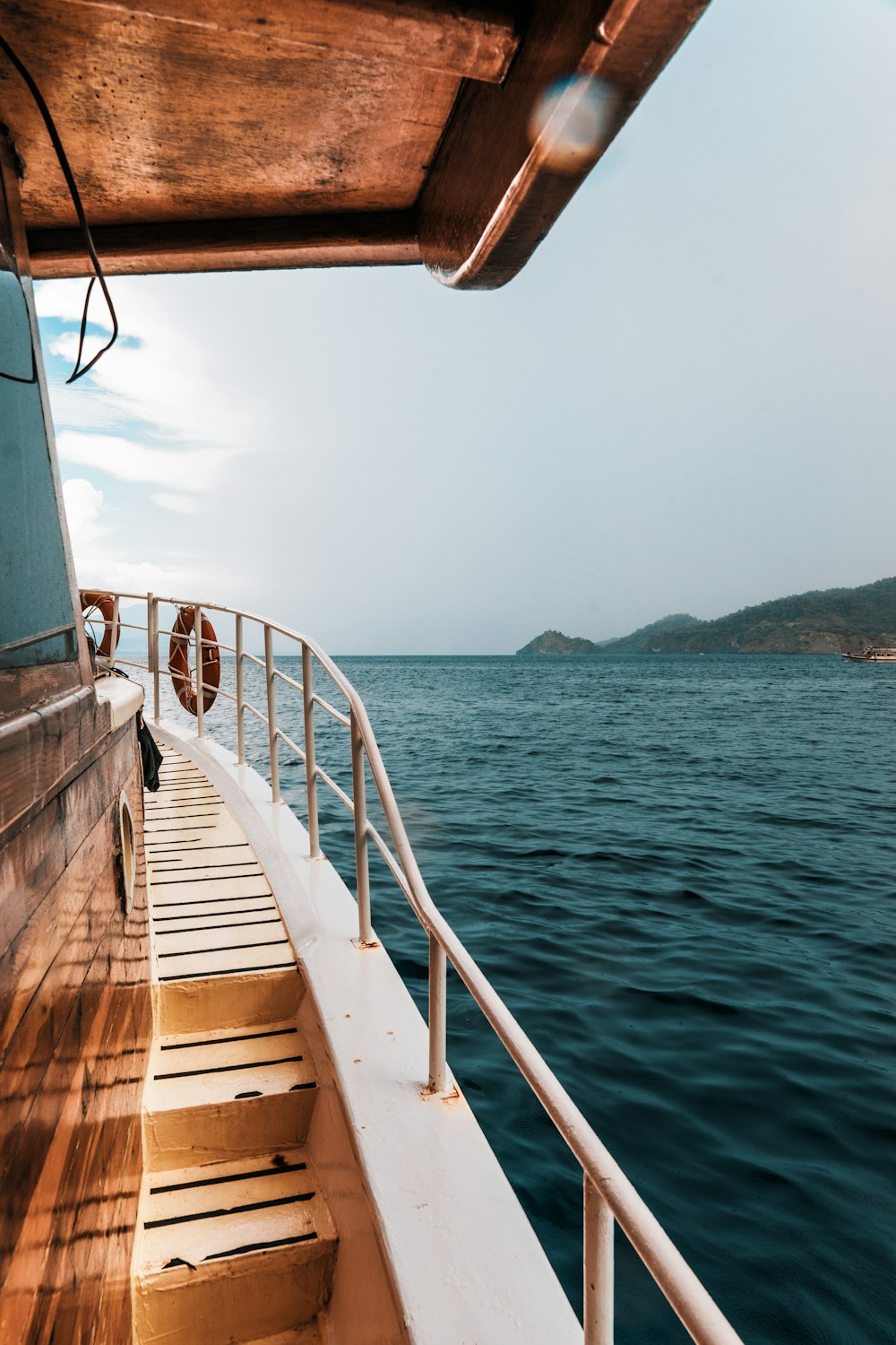 white and brown wooden dock on blue sea during daytime