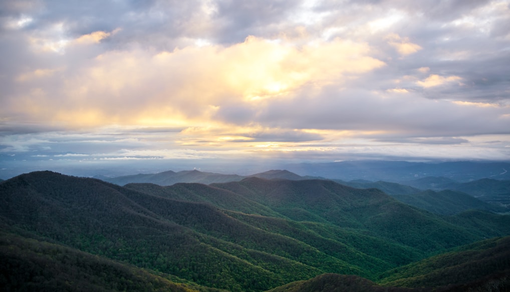 green mountains under white clouds during daytime