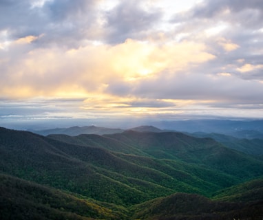 green mountains under white clouds during daytime