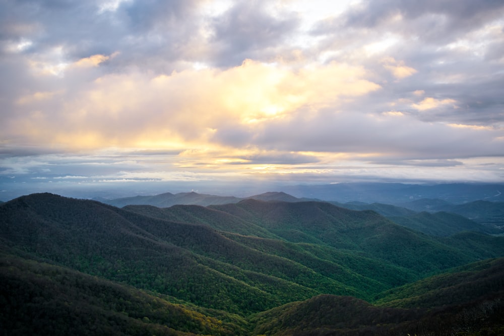 green mountains under white clouds during daytime