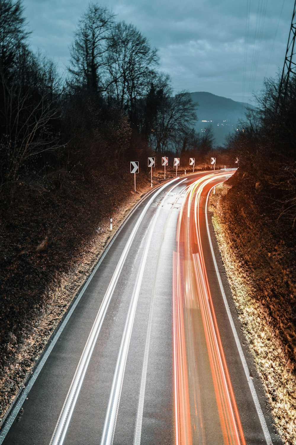 a long exposure photo of a highway at night