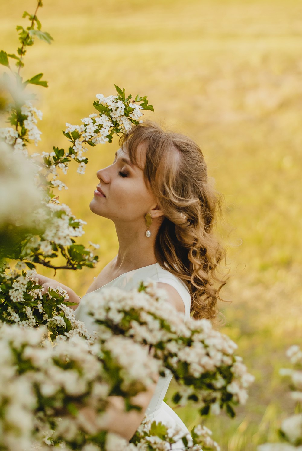 woman in white floral dress smiling