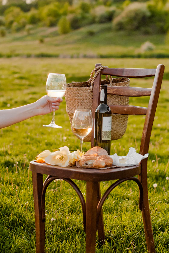 Pouring Santorini wine at a luxury caldera picnic