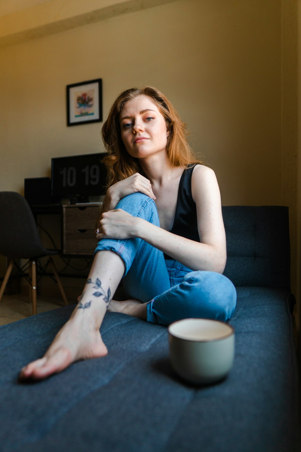 a woman sitting on a couch with her legs crossed