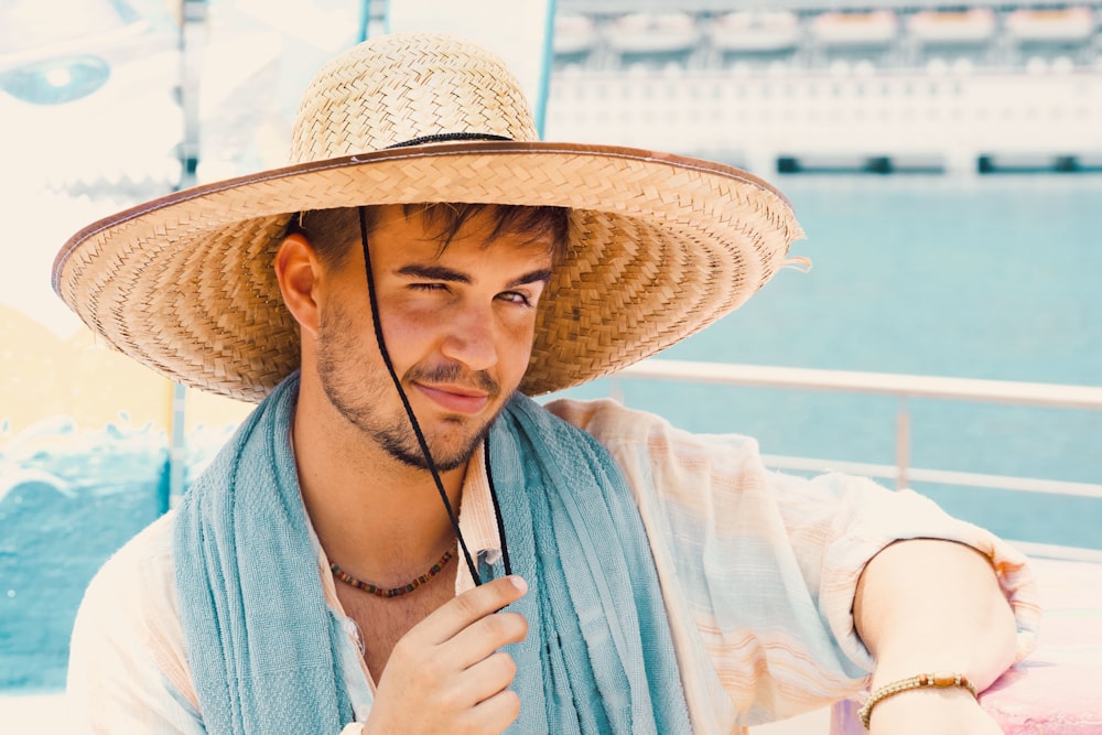 woman in blue and white stripe dress wearing brown straw hat