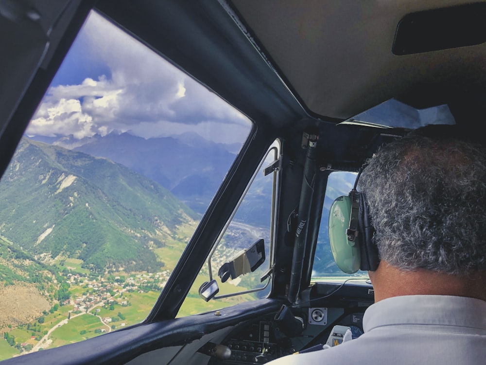 man in white collared shirt driving car during daytime