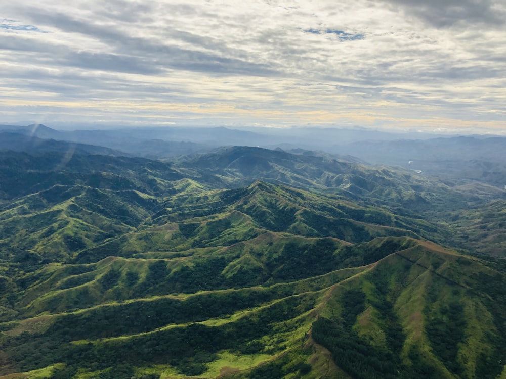 green mountains under white clouds during daytime