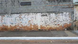 A wall before and after graffiti removal, showing a clean surface.
