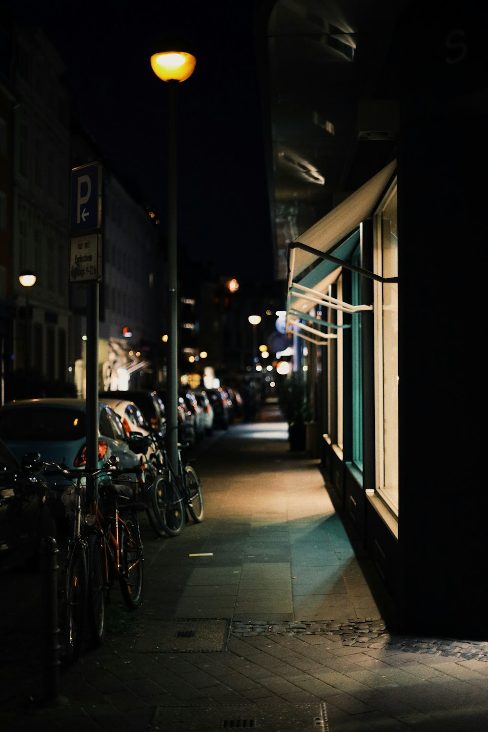 black motorcycle parked beside white and black bus during night time