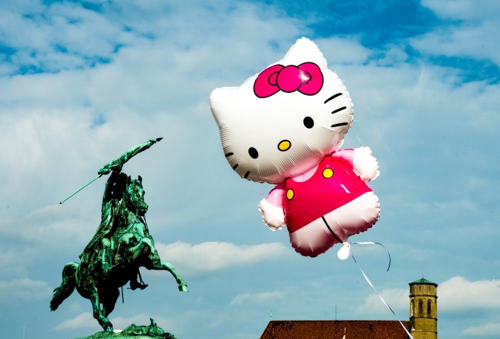 hello kitty balloon on tree branch