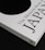 A close-up of a book titled 'The Monocle Book of Japan' with a sleek black and white cover. The book is positioned on a dark surface, creating a contrast with its white cover that features bold black text and a minimalist design.