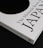 A close-up of a book titled 'The Monocle Book of Japan' with a sleek black and white cover. The book is positioned on a dark surface, creating a contrast with its white cover that features bold black text and a minimalist design.