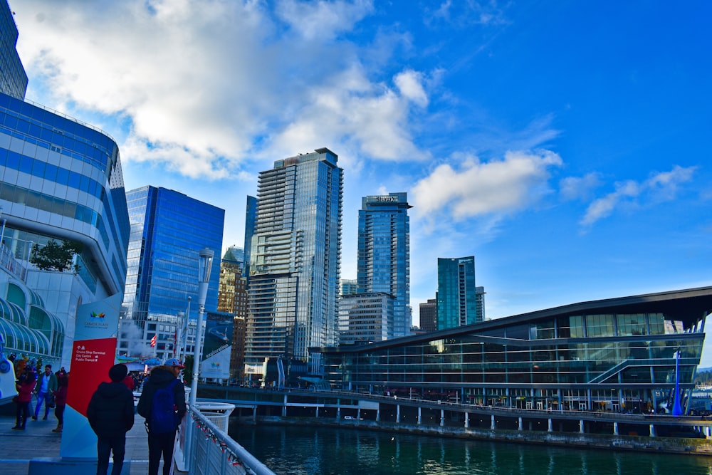 man in black jacket walking on bridge during daytime