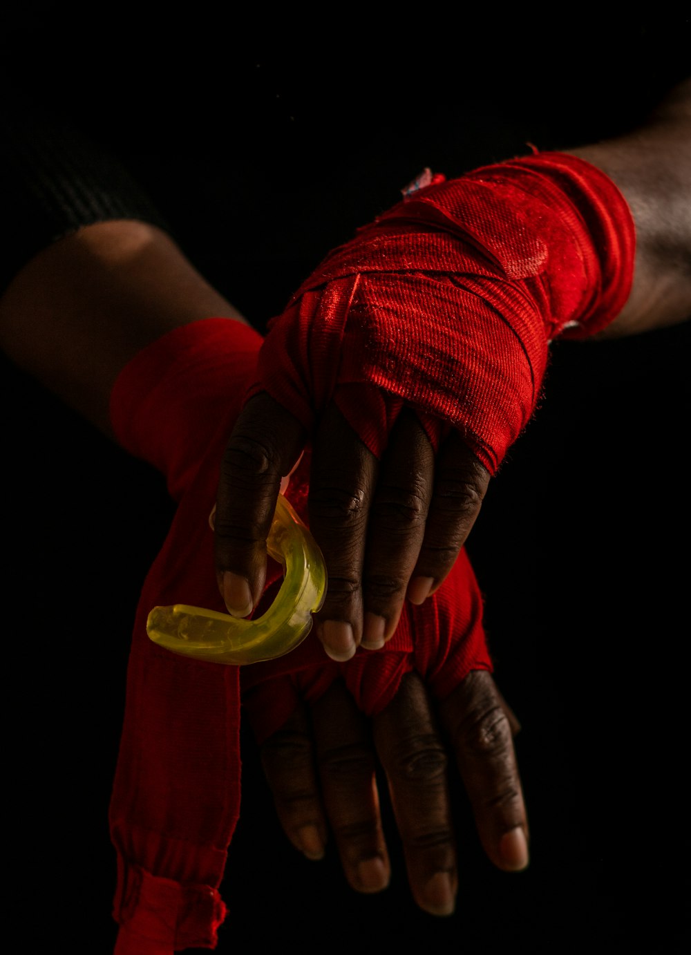 person in red long sleeve shirt with green and yellow paint on hand