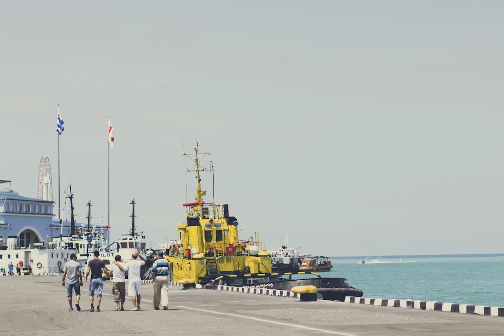 yellow and black heavy equipment on dock during daytime