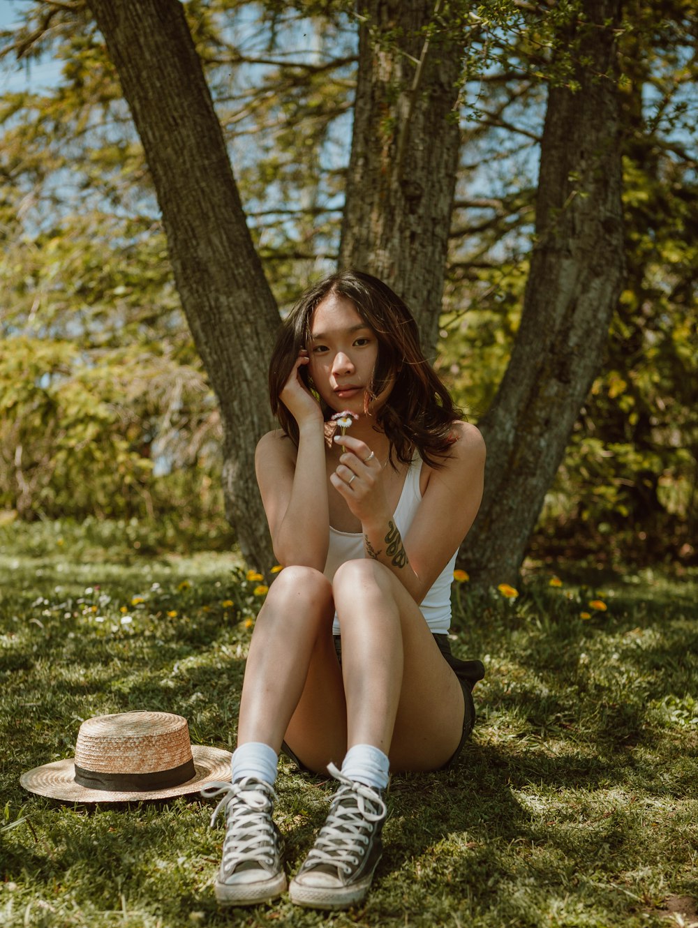 woman in white shorts sitting on brown wooden seat