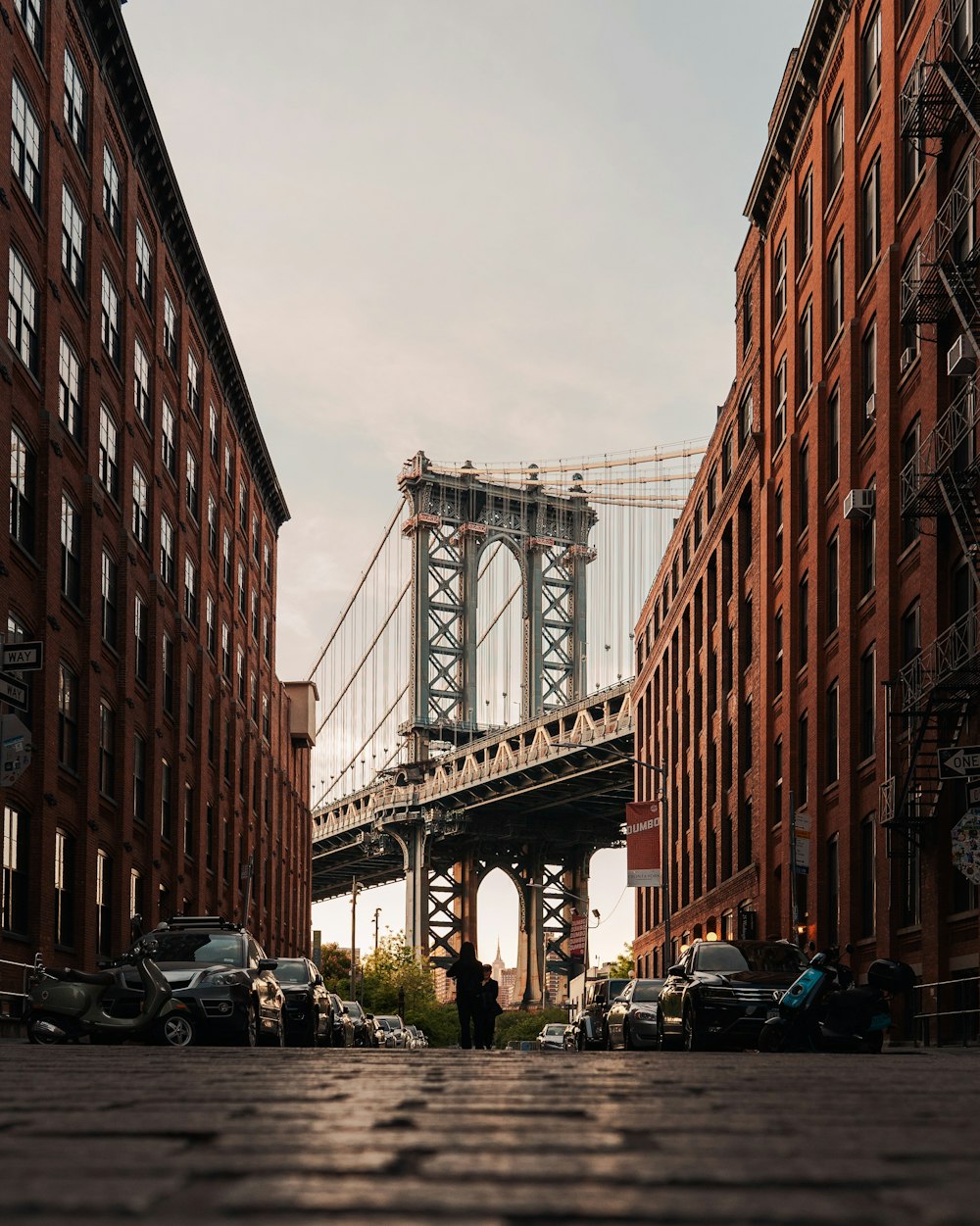 cars parked on side of the road near bridge during daytime