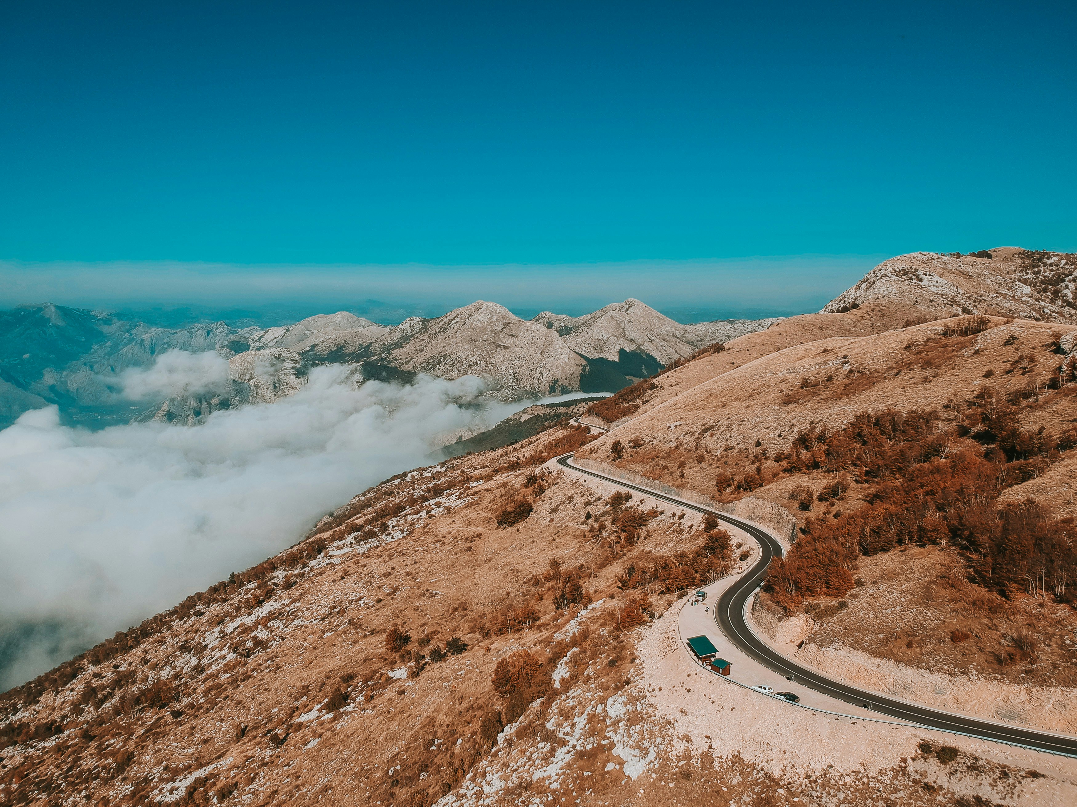 road in the middle of brown mountains