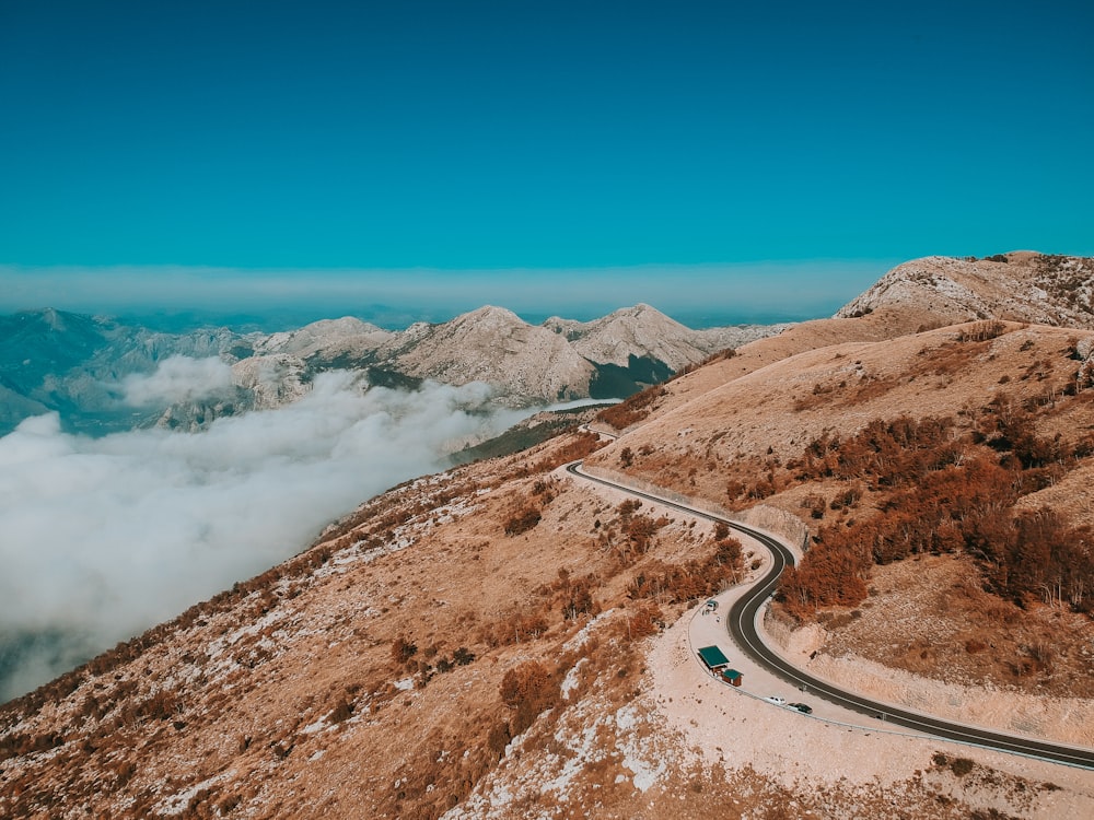 road in the middle of brown mountains