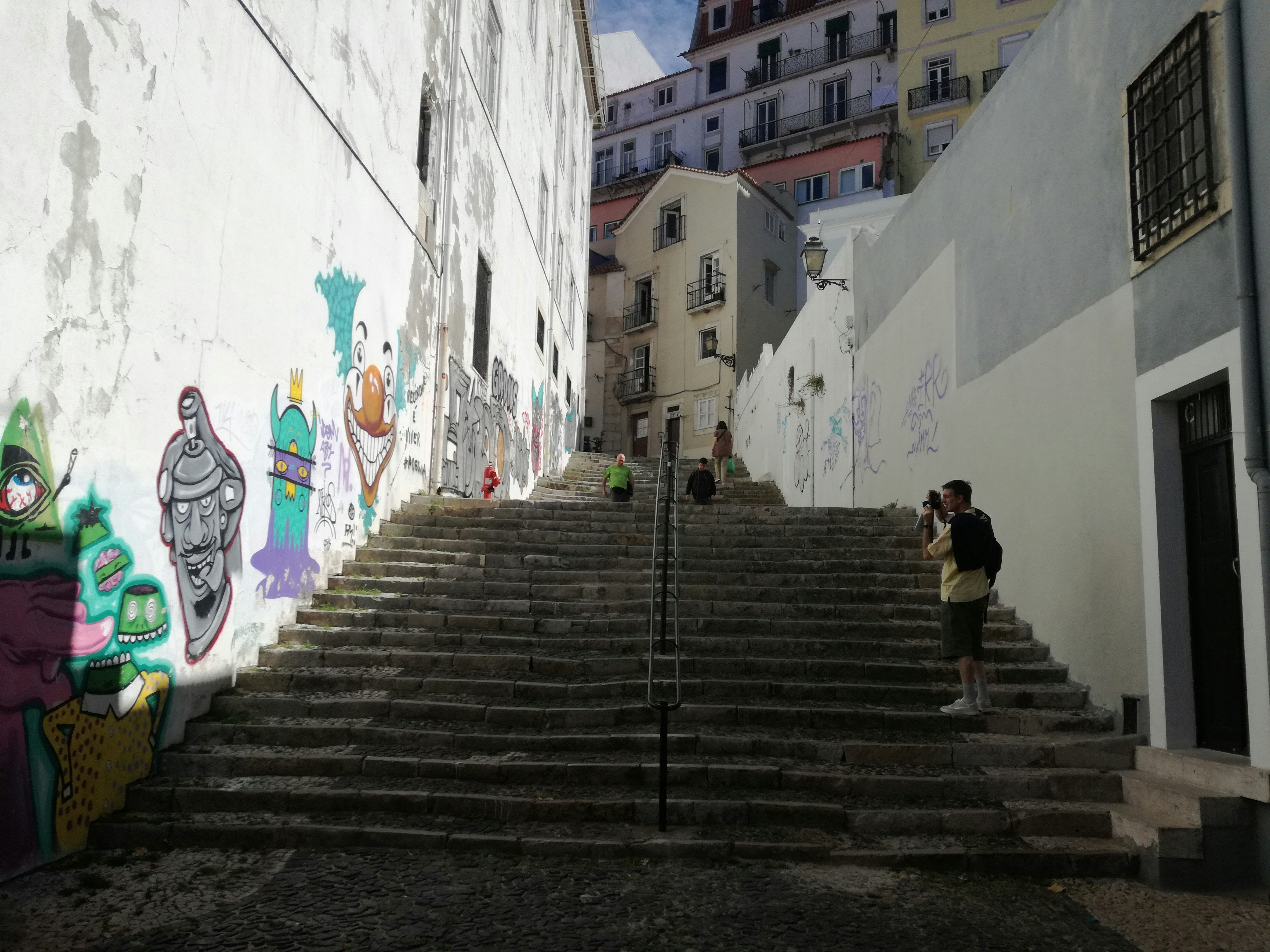 woman in black jacket walking on gray concrete stairs