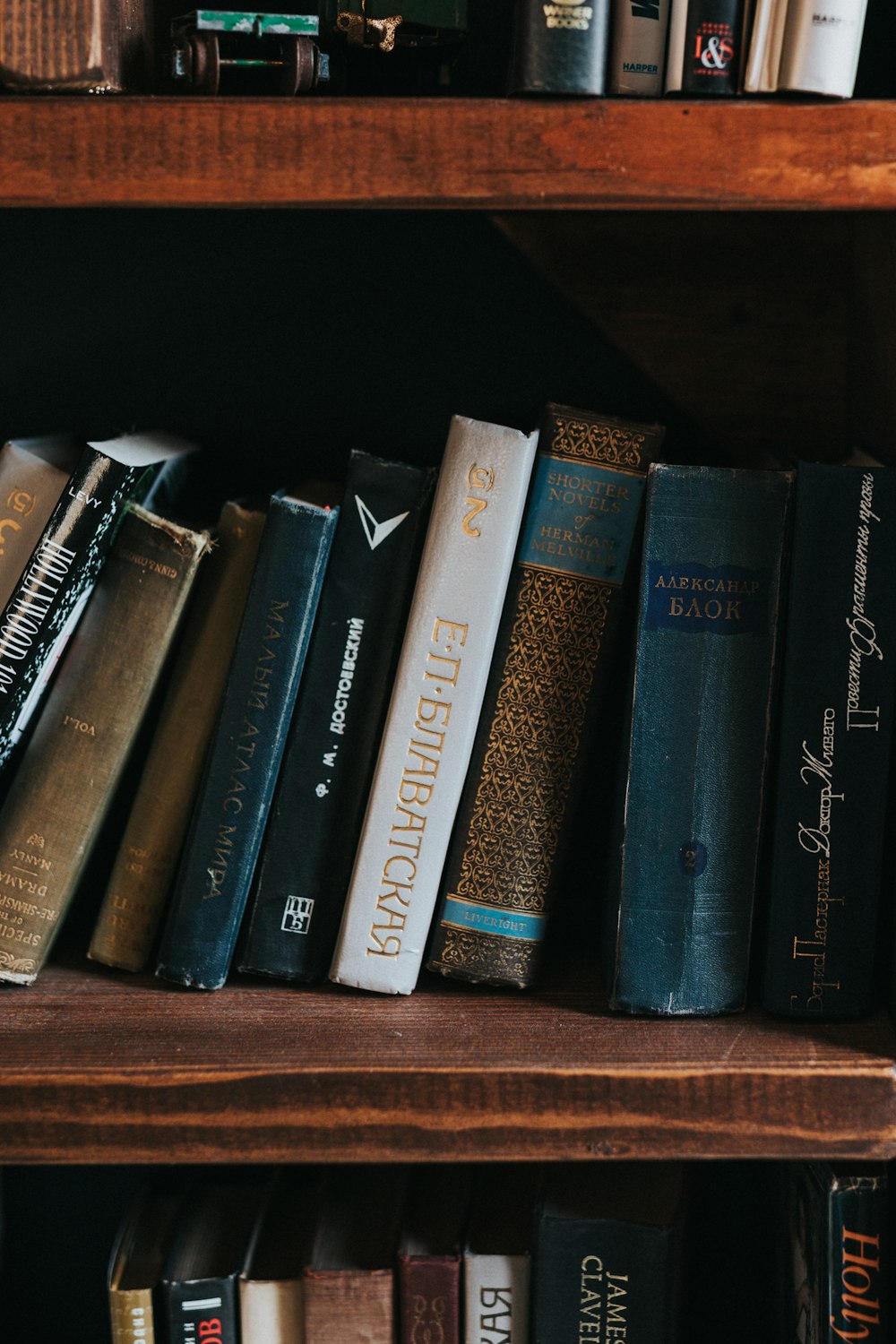 piled books on brown wooden shelf