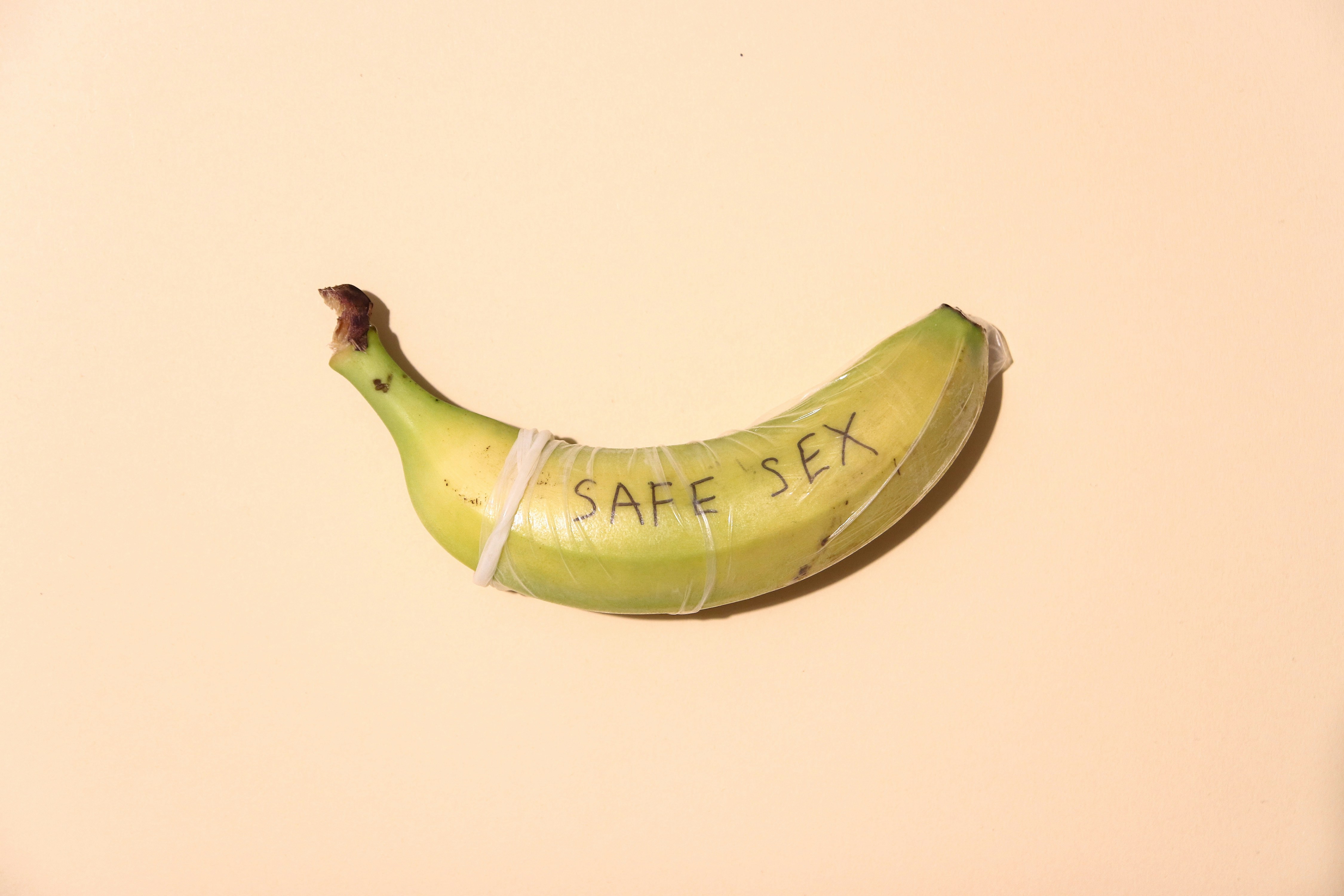 banana with a condom and safe sex written on it