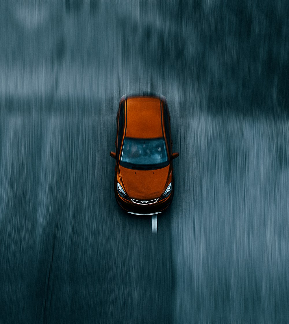 orange and black car on water