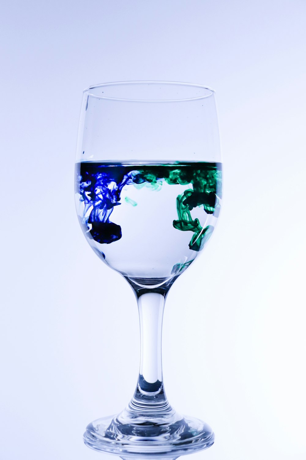 clear wine glass with green leaf