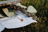 A delicate gold necklace with a shimmering pendant resting on a rustic wooden table.