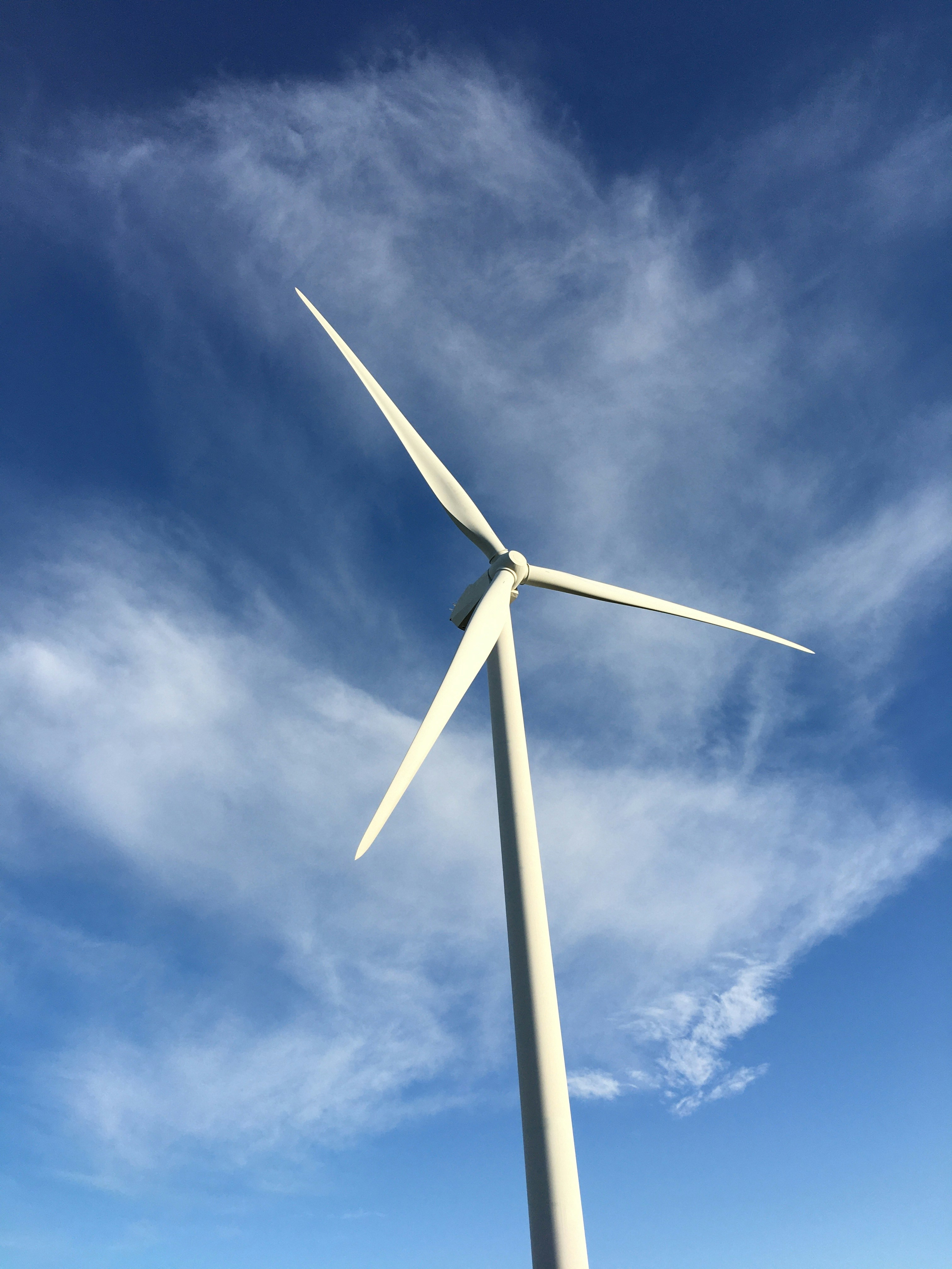 White wind turbine under blue sky and white clouds during daytime photo ...