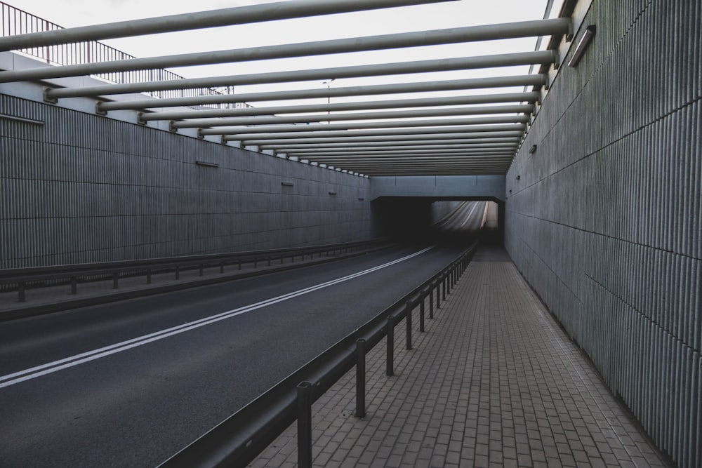 gray concrete tunnel with gray metal railings