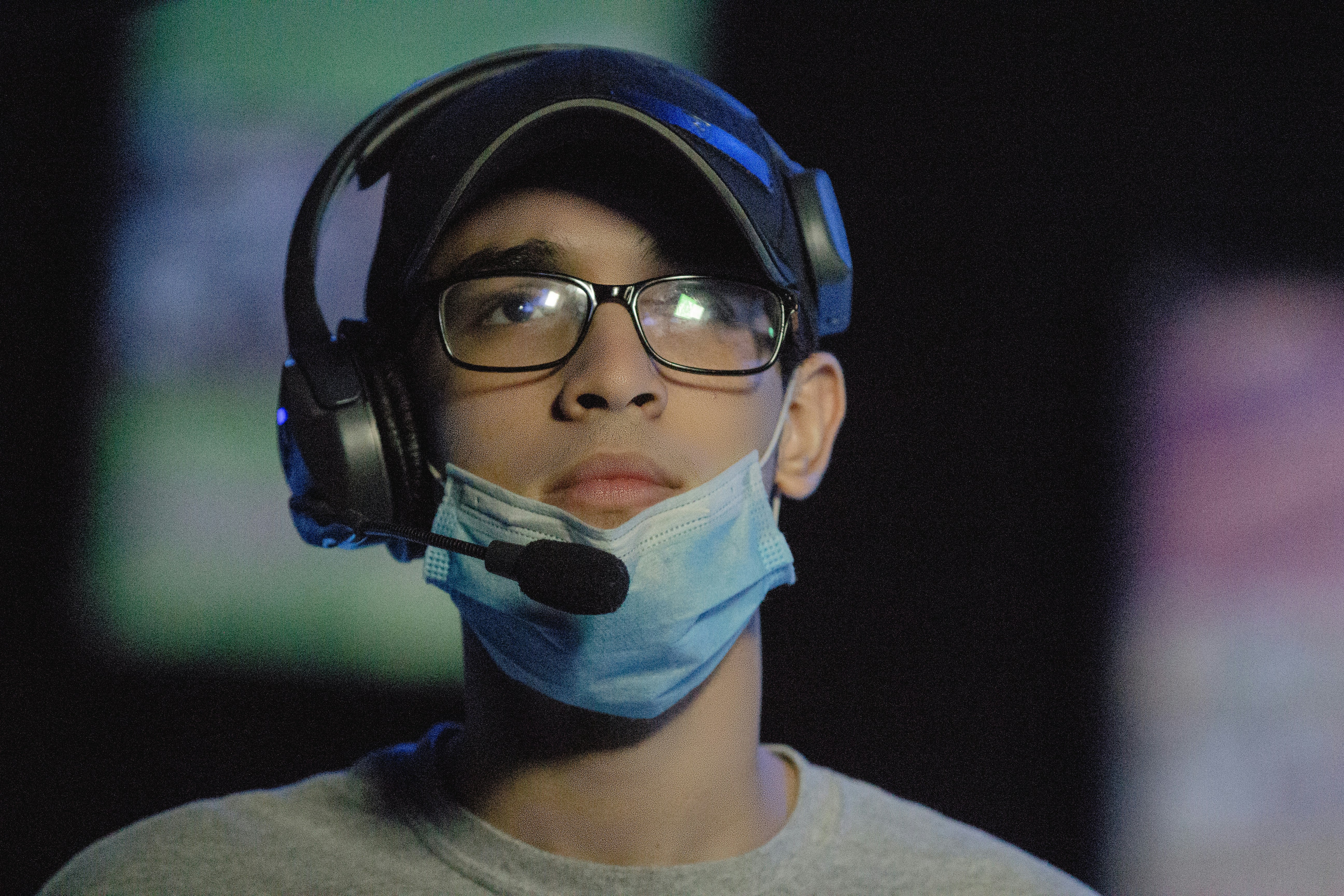 man in gray crew neck shirt wearing blue and black headphones
