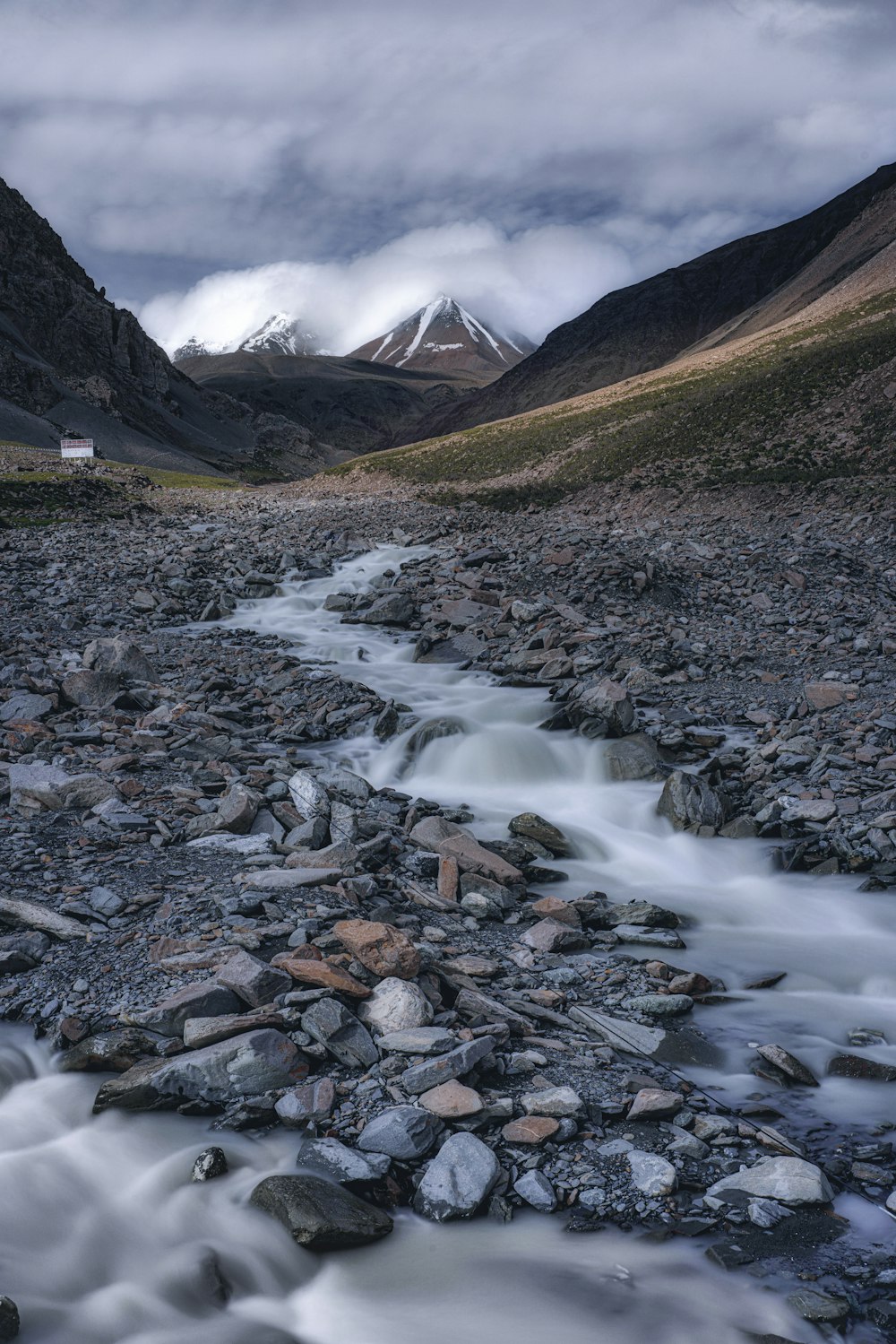 brown rocky mountain with white clouds