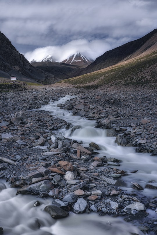 brown rocky mountain with white clouds in Qinghai China