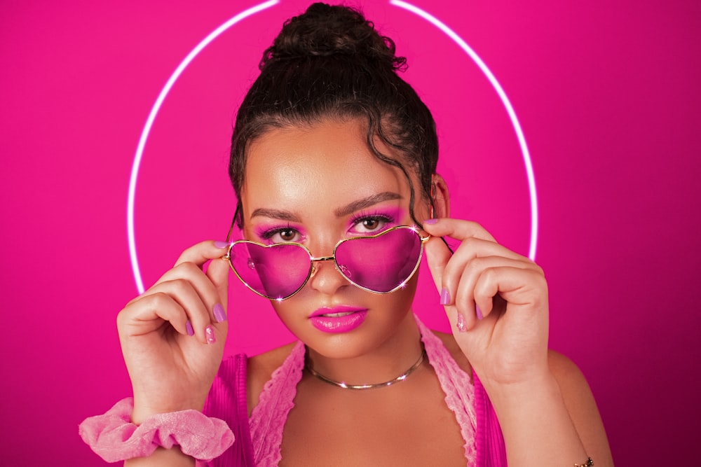 girl in pink framed sunglasses