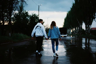 man and woman walking on the street during daytime