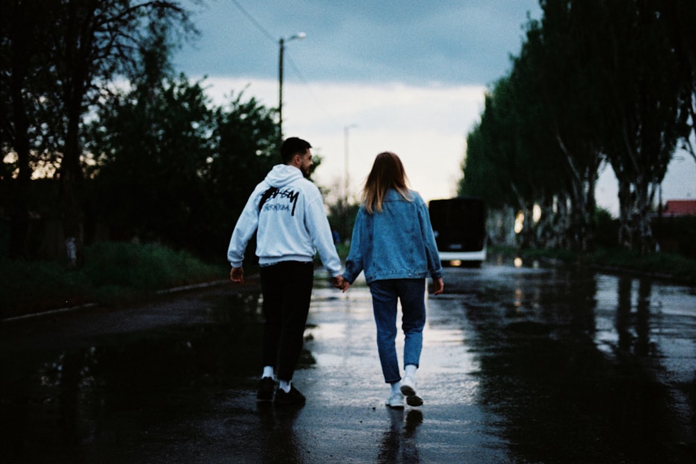 man and woman walking on the street during daytime