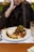 A satisfied diner at a Chicago halal restaurant with a delicious plate of food.