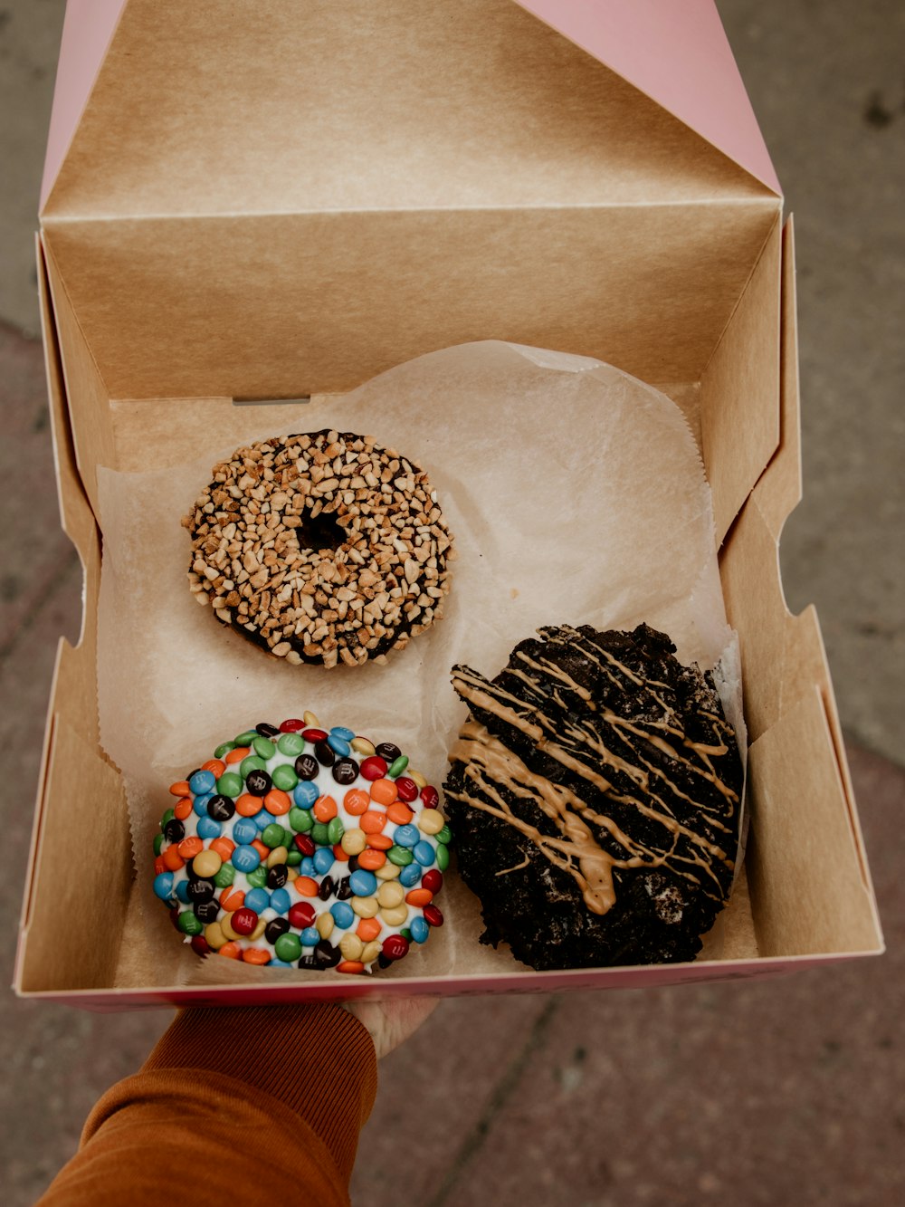 white and black doughnut on brown cardboard box