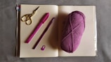 purple yarn beside silver scissors
