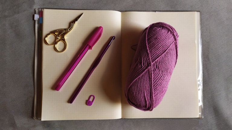 An open notebook with sewing patterns and sketches.