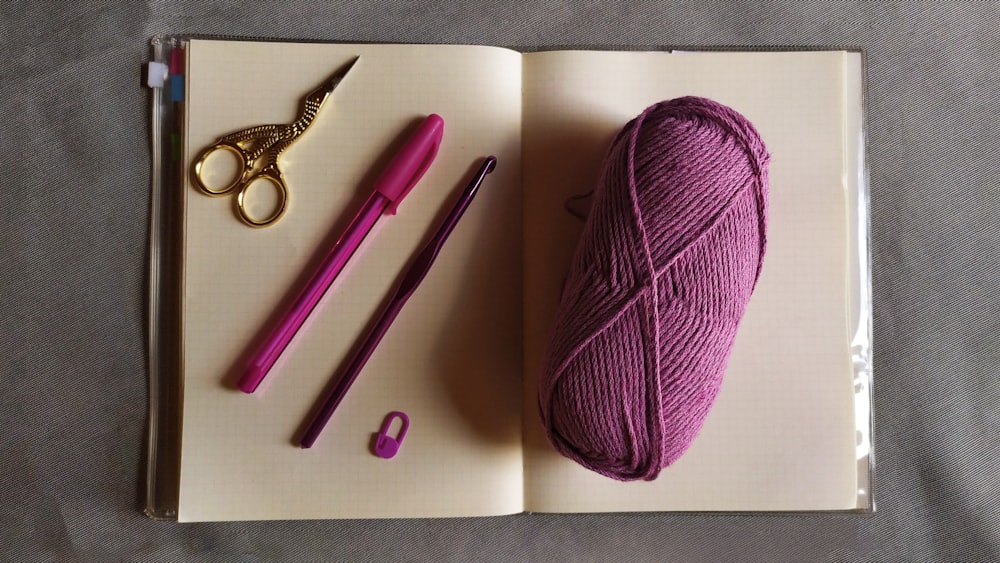 purple yarn beside silver scissors