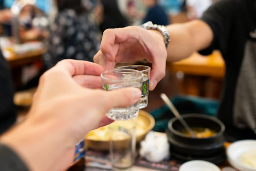Close-up of hands clinking glasses in a celebratory toast.