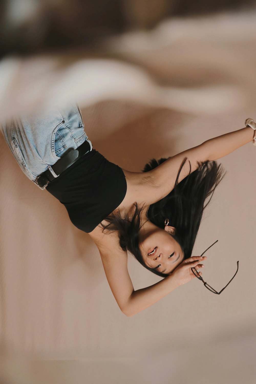 woman in black tank top and blue denim jeans