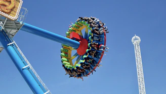 A vibrant photo of families enjoying a thrilling amusement park ride in Qiddiya.