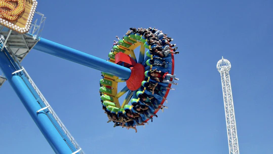 A vibrant photo of families enjoying a thrilling amusement park ride in Qiddiya.