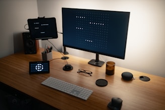 black flat screen computer monitor on brown wooden desk